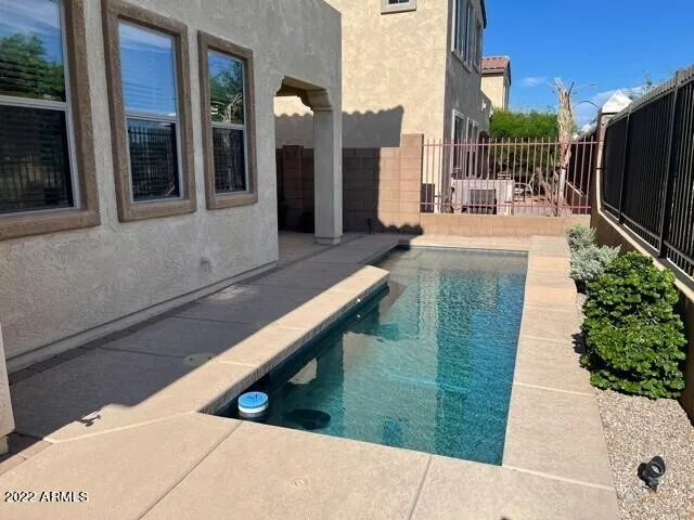 a swimming pool with outdoor seating and yard