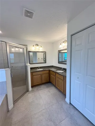 a kitchen with stainless steel appliances a refrigerator a sink a stove and cabinets