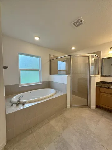 a spacious bathroom with a tub and shower