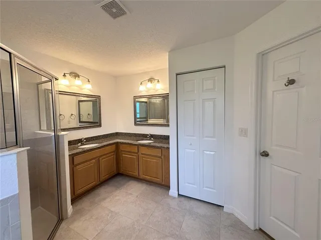 a large kitchen with cabinets and stainless steel appliances