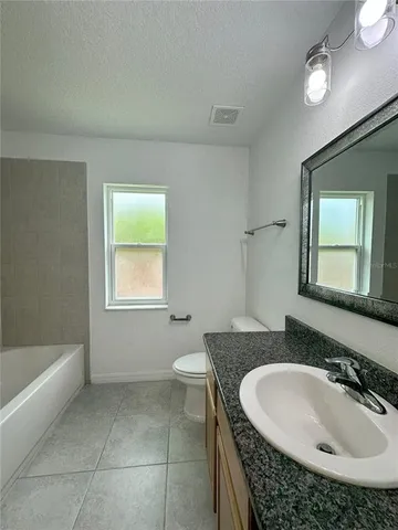 a bathroom with a sink a toilet and bathtub