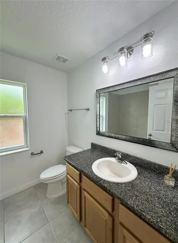 a bathroom with a sink toilet and mirror