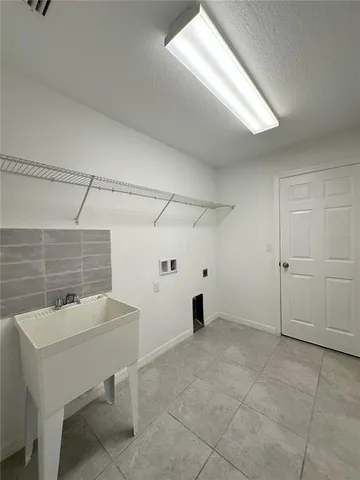 a view of a room with furniture and window