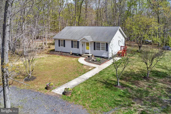 an aerial view of a house with swimming pool and sitting area
