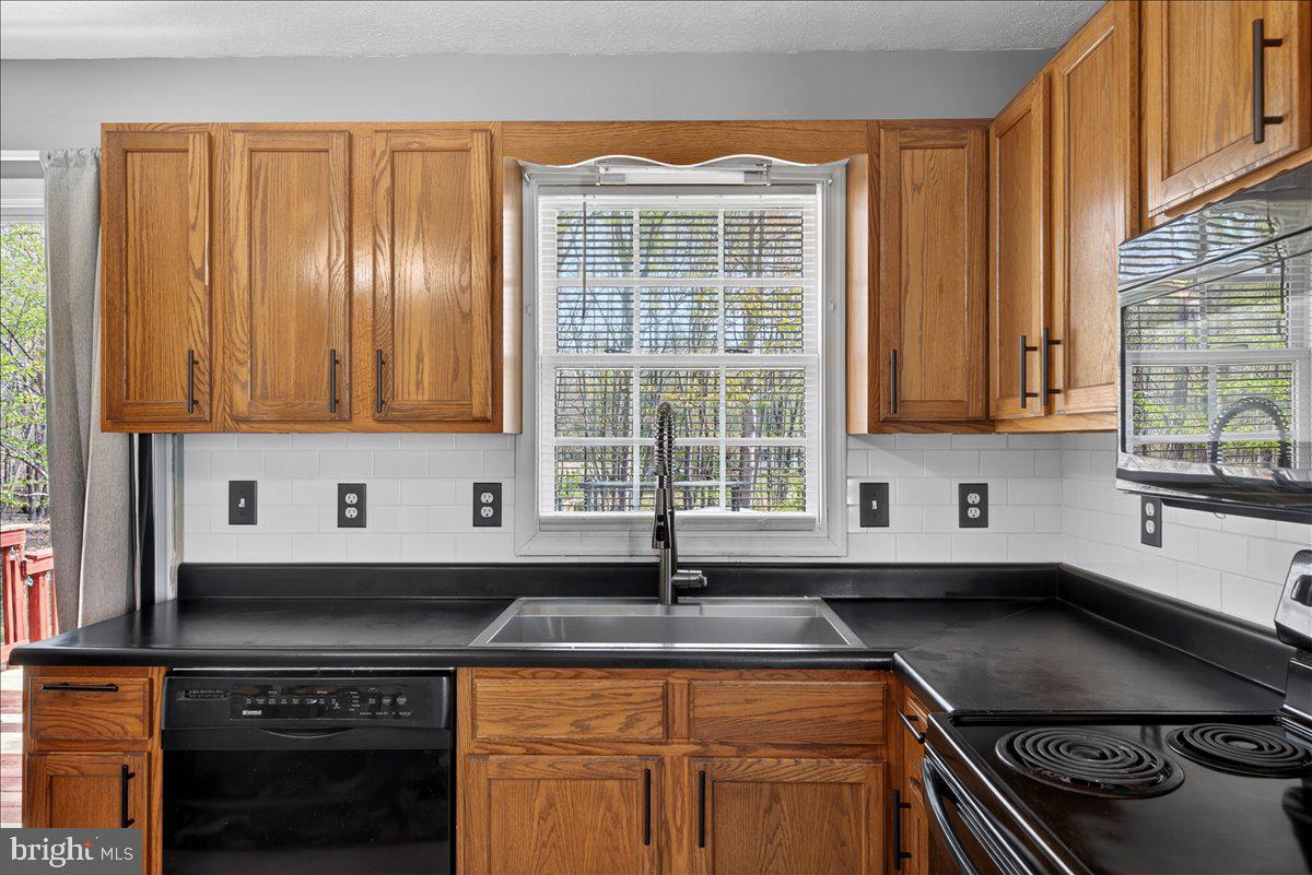 6265 Browning Road Culpeper, VA 22701 - Photo 13 of 74 a kitchen with stainless steel appliances a sink stove and cabinets