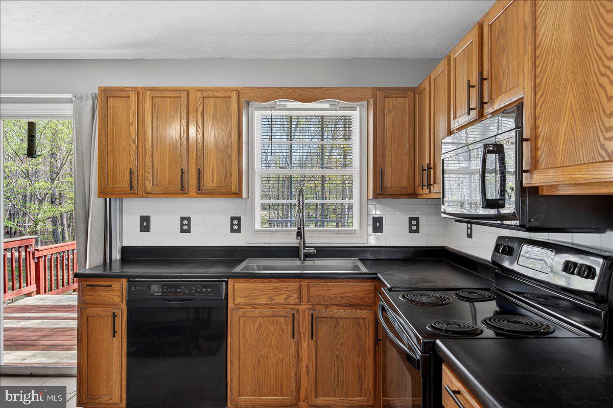 6265 Browning Road Culpeper, VA 22701 - Photo 14 of 74 a kitchen with stainless steel appliances granite countertop a stove a sink and a microwave