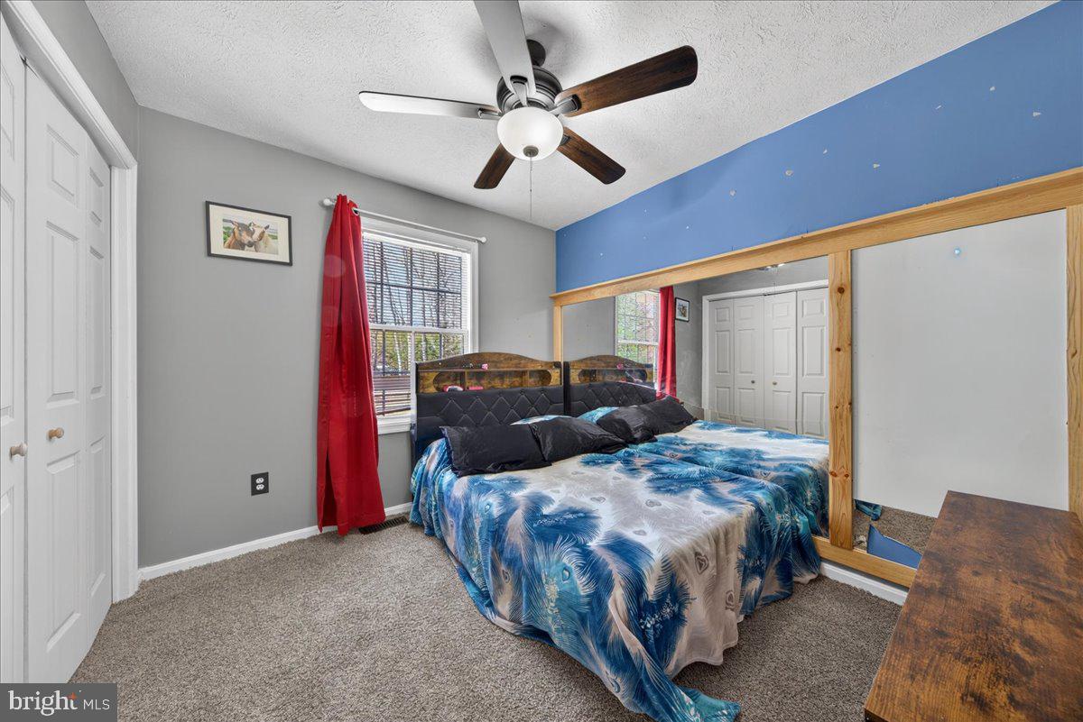6265 Browning Road Culpeper, VA 22701 - Photo 21 of 74 a bedroom with two beds and a ceiling fan