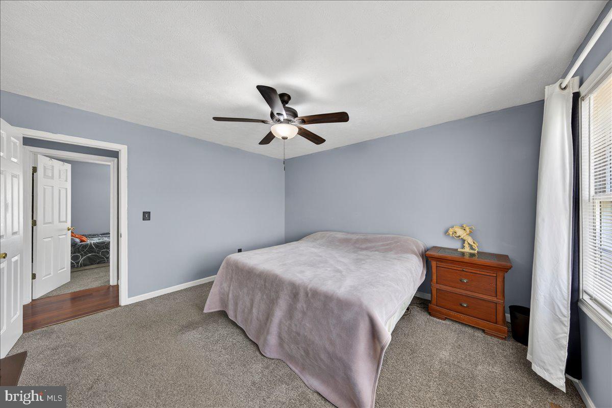 6265 Browning Road Culpeper, VA 22701 - Photo 26 of 74 a bedroom with a bed and a ceiling fan