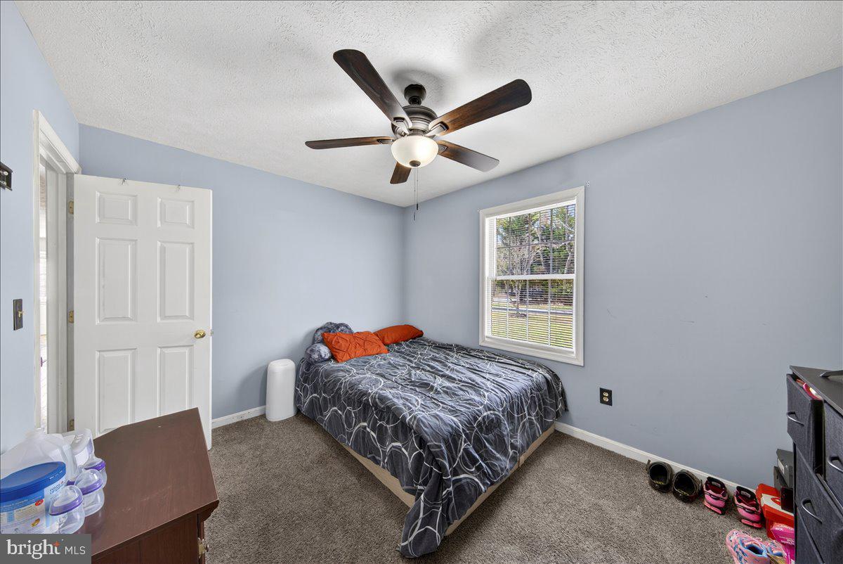 6265 Browning Road Culpeper, VA 22701 - Photo 30 of 74 a bedroom with a bed and a ceiling fan