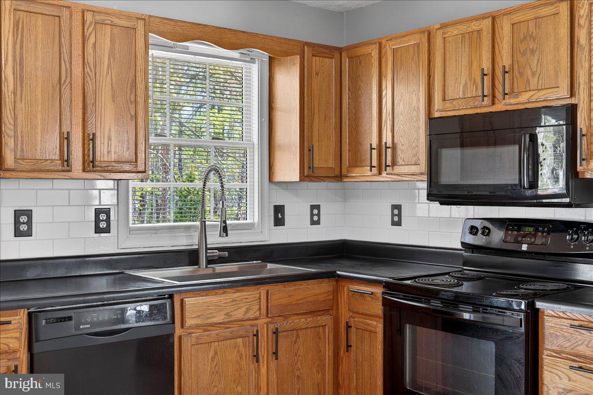 6265 Browning Road Culpeper, VA 22701 - Photo 32 of 74 a kitchen with granite countertop a stove sink and cabinets
