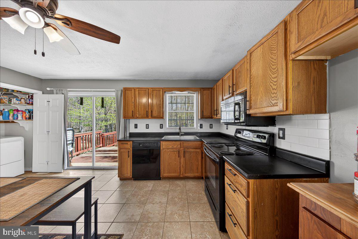 6265 Browning Road Culpeper, VA 22701 - Photo 34 of 74 a kitchen with a stove a sink and a refrigerator