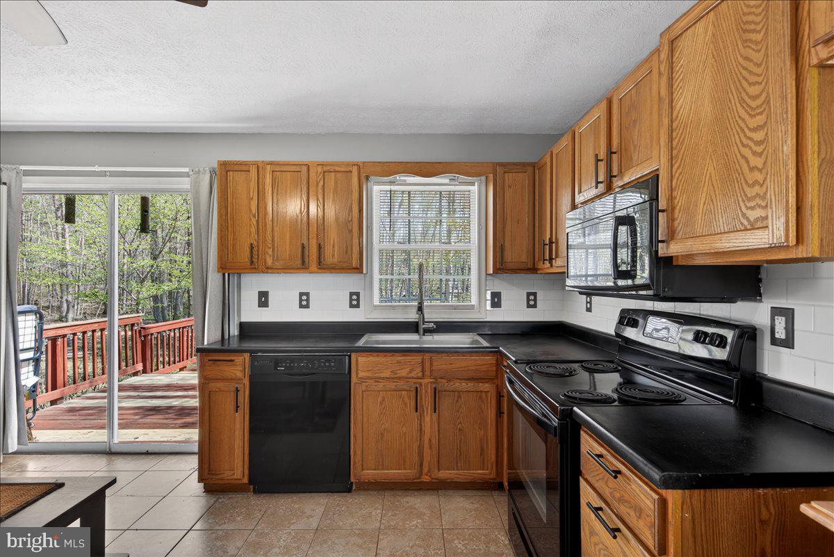 6265 Browning Road Culpeper, VA 22701 - Photo 35 of 74 a kitchen with a stove a sink and a microwave