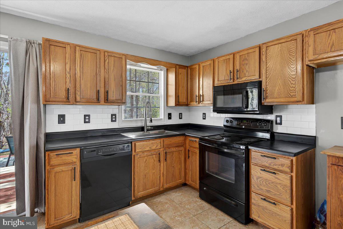 6265 Browning Road Culpeper, VA 22701 - Photo 36 of 74 a kitchen with stainless steel appliances granite countertop a stove a sink dishwasher and a microwave oven with cabinets