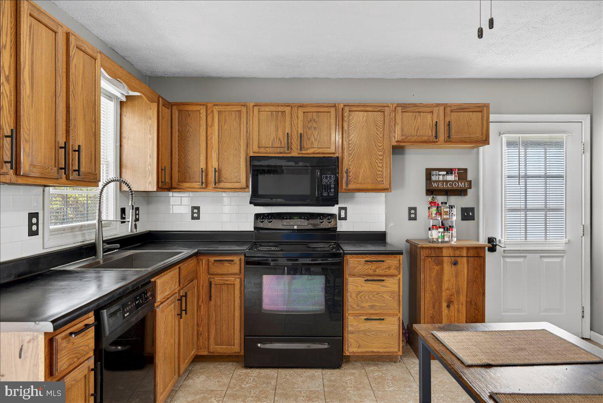 6265 Browning Road Culpeper, VA 22701 - Photo 39 of 74 a kitchen with stainless steel appliances granite countertop a stove a sink and a microwave