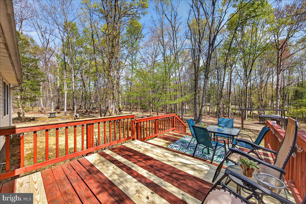 6265 Browning Road Culpeper, VA 22701 - Photo 40 of 74 a view of a patio with table and chairs and wooden floor
