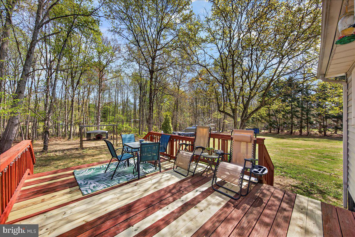6265 Browning Road Culpeper, VA 22701 - Photo 41 of 74 a view of a patio with table and chairs floor to ceiling and a yard