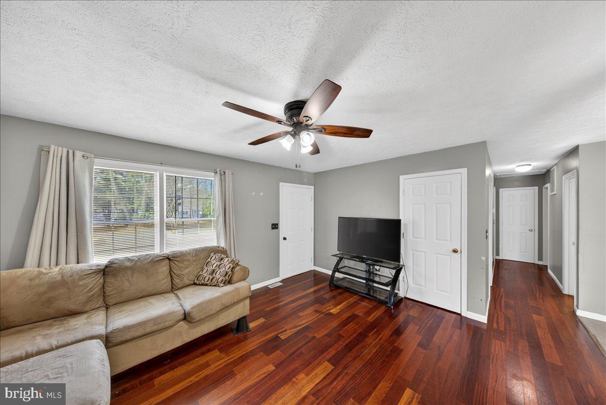 6265 Browning Road Culpeper, VA 22701 - Photo 7 of 74 a living room with furniture and a flat screen tv with wooden floor