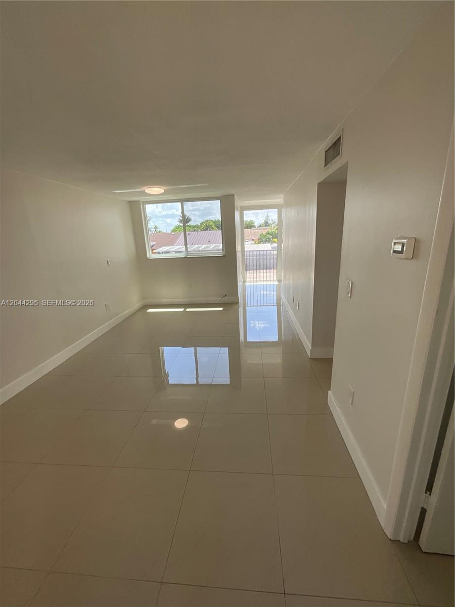 9441 Southwest 4th Street, Unit 214 Miami, FL 33174 - Photo 6 of 22 a view of a hallway with an empty room