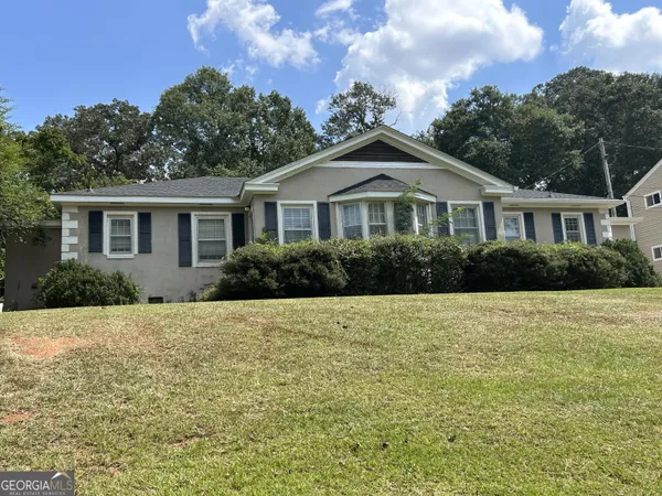 a front view of a house with a garden