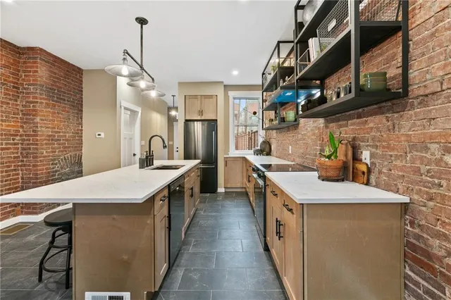 a kitchen with stainless steel appliances a sink and a refrigerator