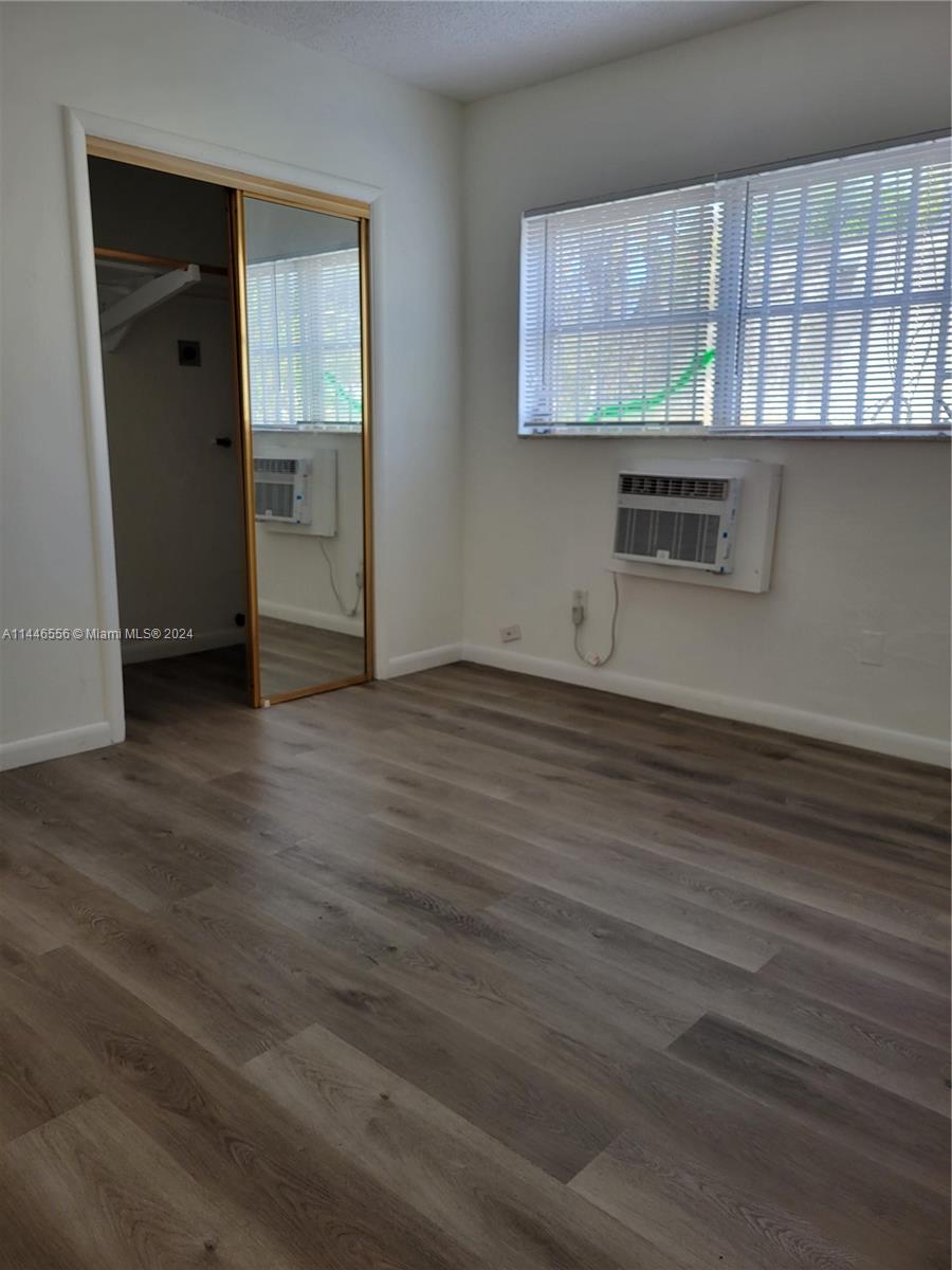 1755 Northeast 116th Road, Unit 9 North Miami, FL 33181 - Photo 11 of 27 wooden floor in an empty room