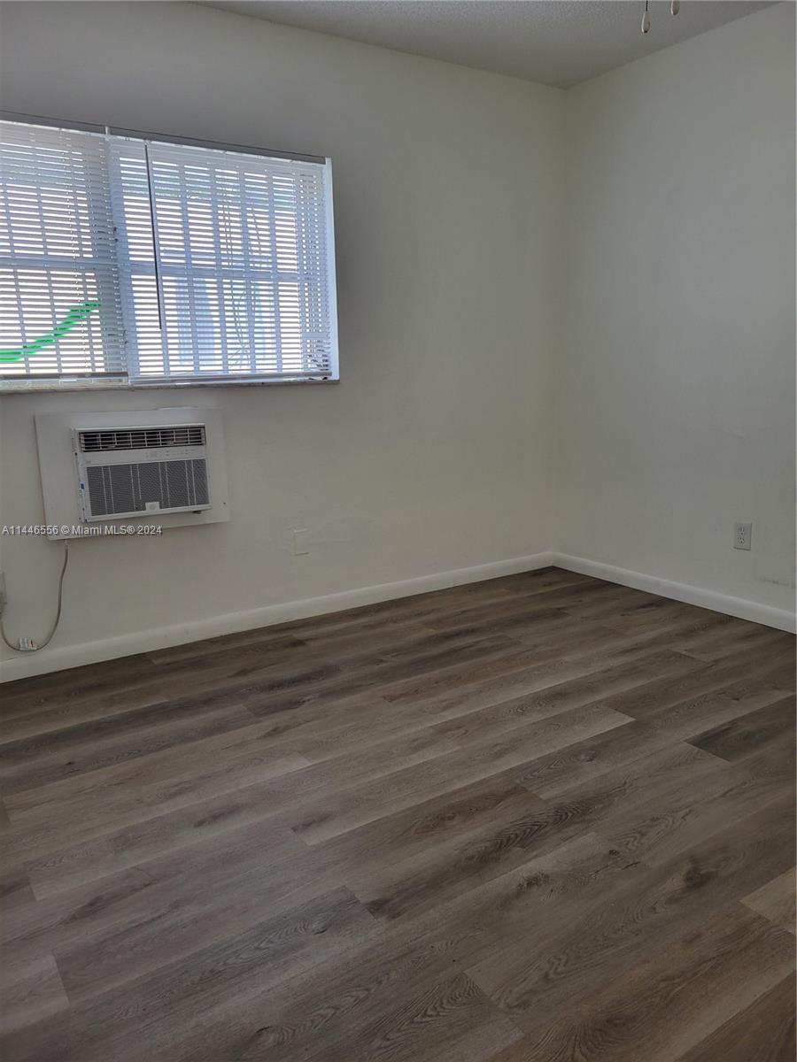 1755 Northeast 116th Road, Unit 9 North Miami, FL 33181 - Photo 14 of 27 a view of a room with wooden floor and windows