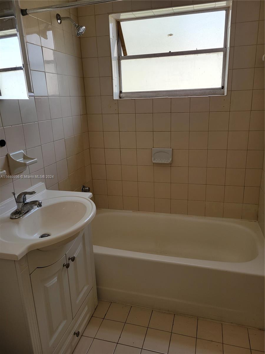 1755 Northeast 116th Road, Unit 9 North Miami, FL 33181 - Photo 17 of 27 a bathroom with a sink a bath tub and a shower