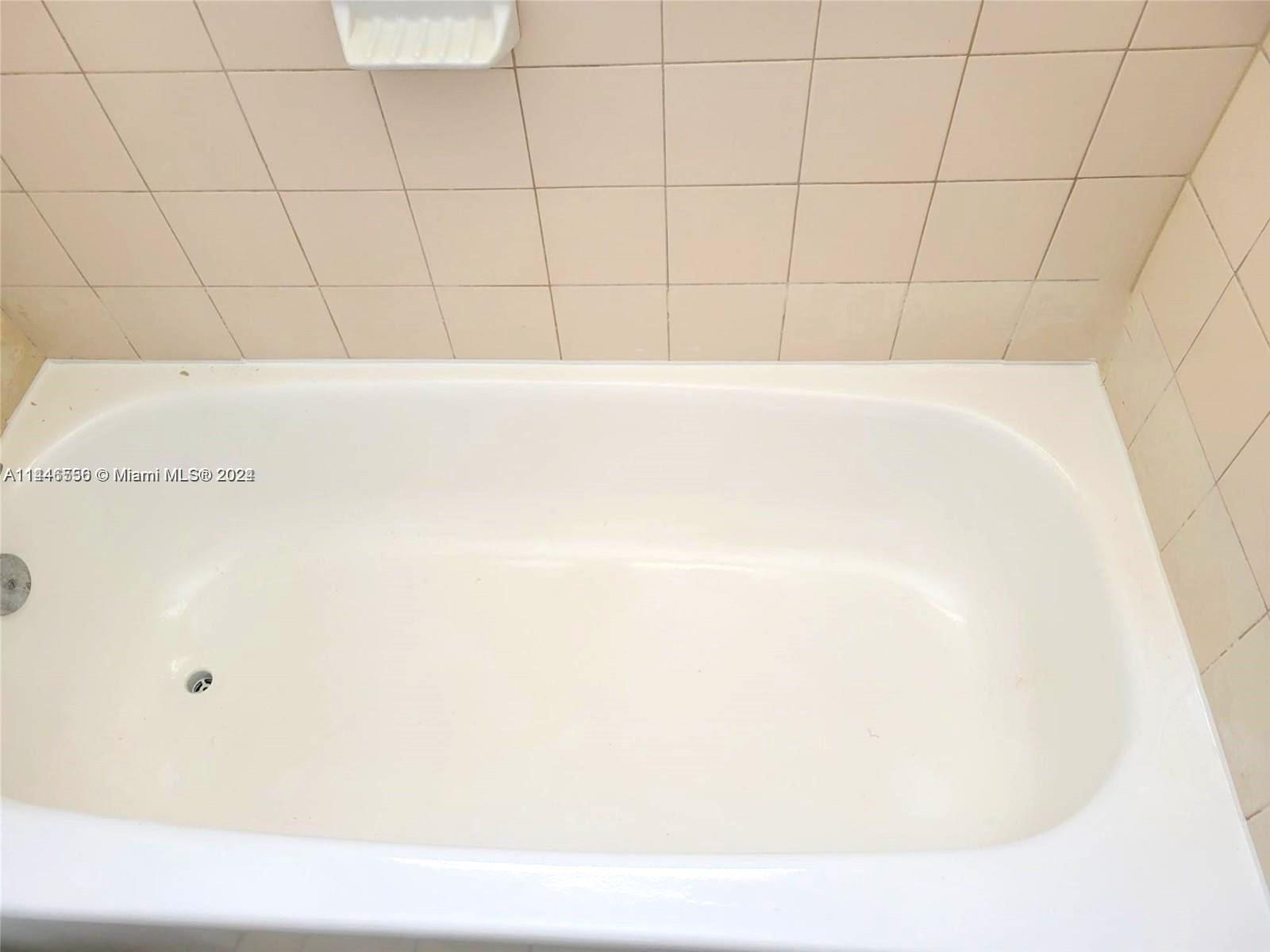 1755 Northeast 116th Road, Unit 9 North Miami, FL 33181 - Photo 18 of 27 a bathroom with a bathtub