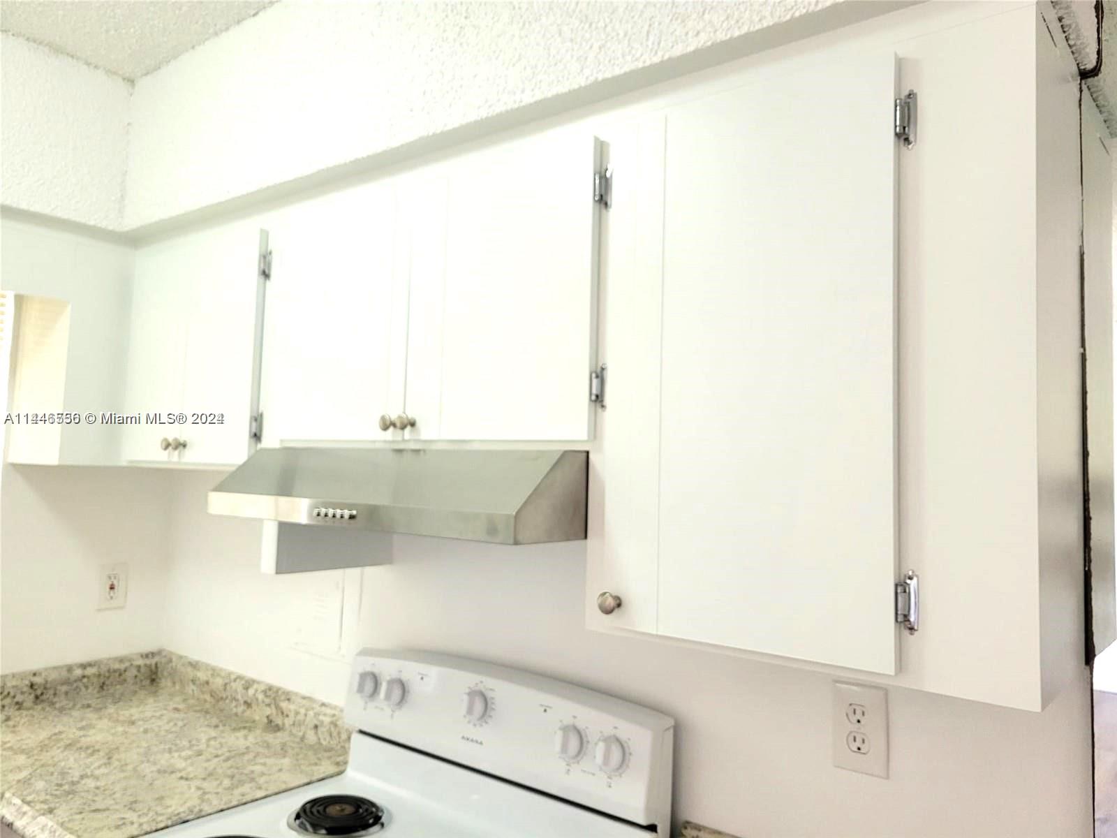 1755 Northeast 116th Road, Unit 9 North Miami, FL 33181 - Photo 19 of 27 a view of a kitchen with a sink and cabinets
