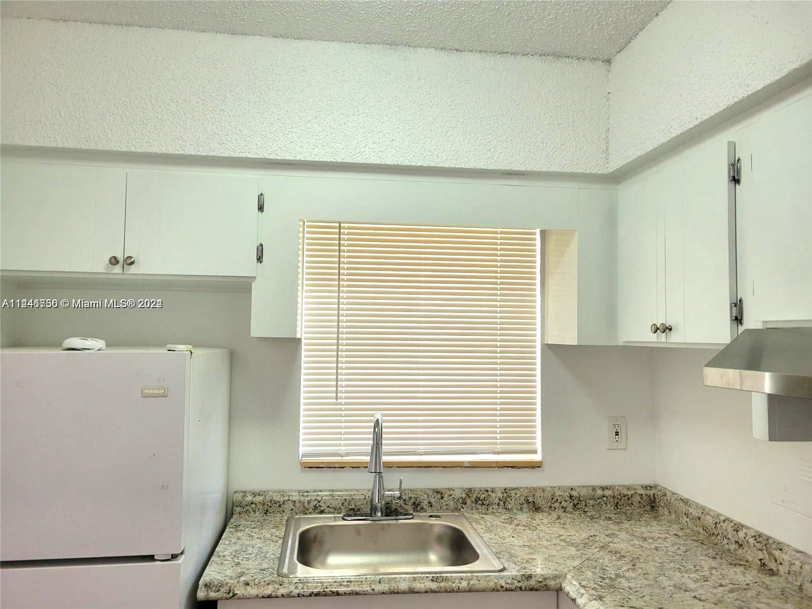 1755 Northeast 116th Road, Unit 9 North Miami, FL 33181 - Photo 20 of 27 a bathroom with a sink and a bathtub