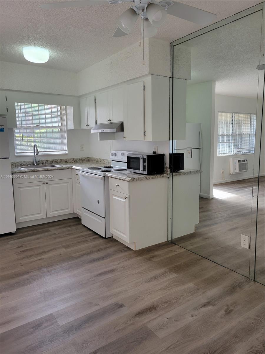 1755 Northeast 116th Road, Unit 9 North Miami, FL 33181 - Photo 4 of 27 a kitchen with a sink and cabinets
