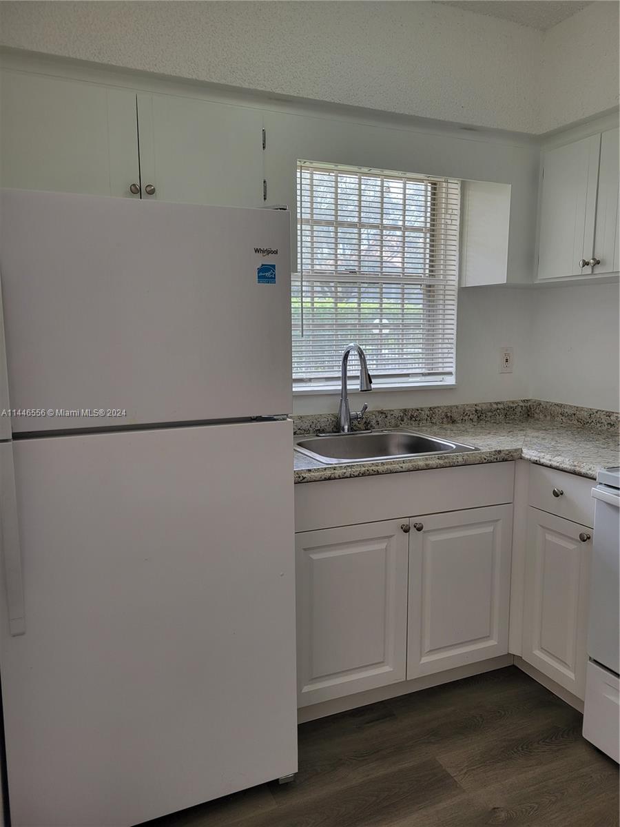 1755 Northeast 116th Road, Unit 9 North Miami, FL 33181 - Photo 5 of 27 a kitchen with stainless steel appliances granite countertop a sink and a window