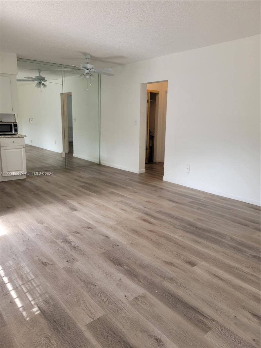 1755 Northeast 116th Road, Unit 9 North Miami, FL 33181 - Photo 8 of 27 a view of empty room with wooden floor