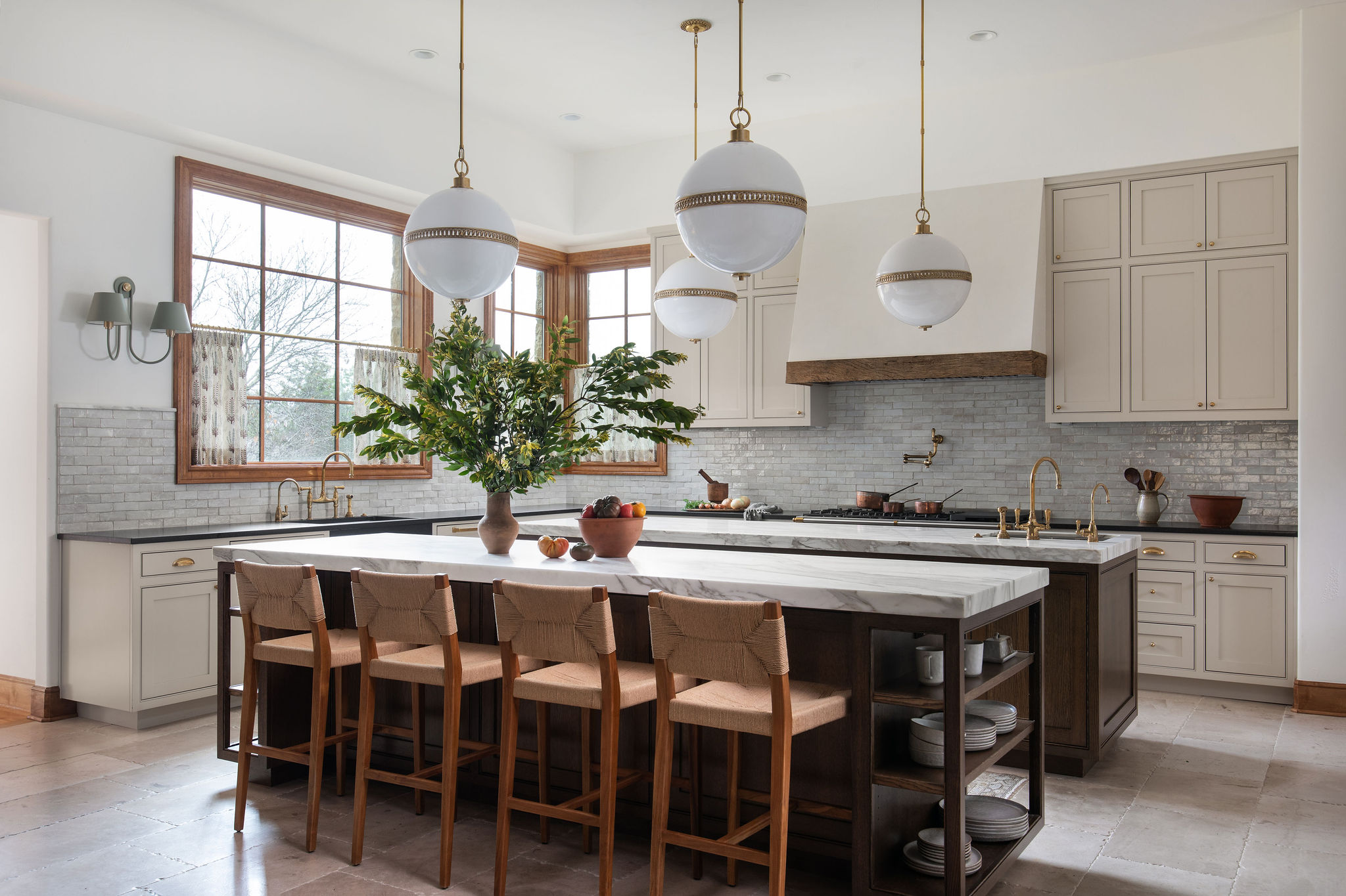 a kitchen with stainless steel appliances a sink a stove a table and chairs