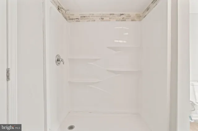 a bathroom with a glass shower door
