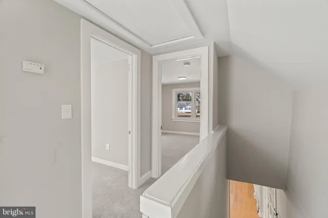 a view of a hallway with wooden floor and entryway