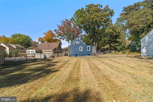 a yellow house with trees in front of it