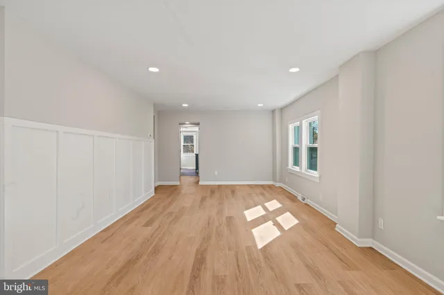 a view of wooden floor and windows in a room
