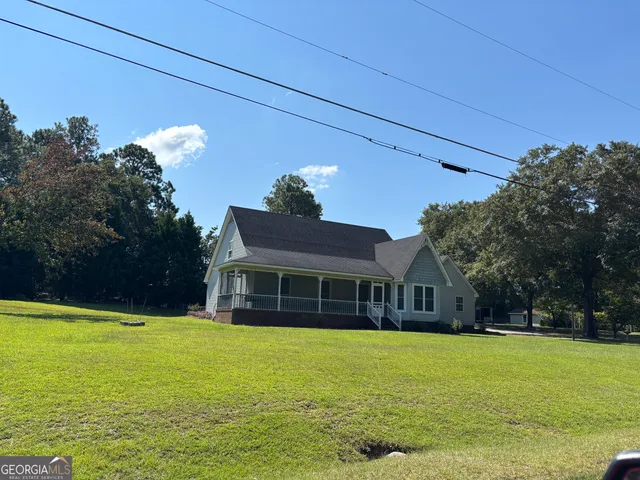 a front view of a house with a yard table and chairs