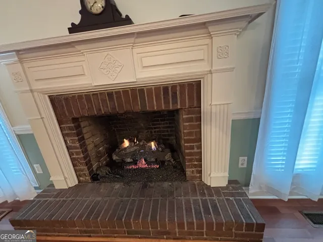 a kitchen with stainless steel appliances kitchen island granite countertop a refrigerator a stove and a sink with granite countertops