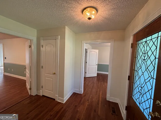 a kitchen with granite countertop a sink cabinets and stainless steel appliances