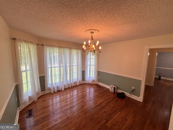 a kitchen with granite countertop a refrigerator a stove a sink a microwave and cabinets