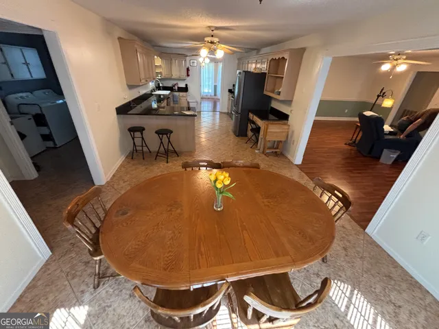 a dining room with furniture and wooden floor
