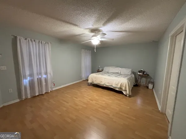 a view of an empty room with wooden floor