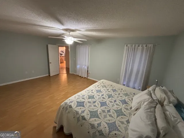 an empty room with closet and a ceiling fan