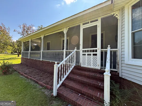 a front view of a house with yard and green space
