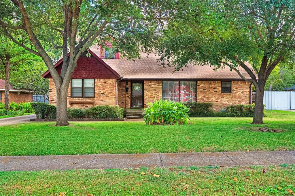 2828 Larkspur Lane Dallas, TX 75233 - Photo 1 of 31 a front view of a house with a yard and garage