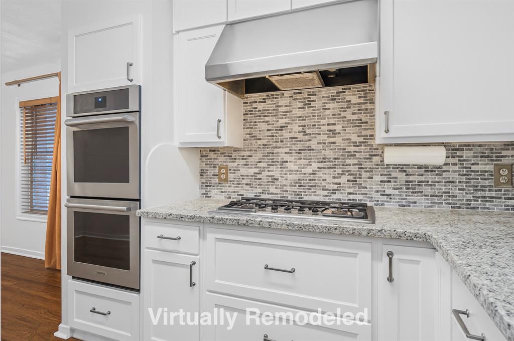 2828 Larkspur Lane Dallas, TX 75233 - Photo 11 of 31 a kitchen with granite countertop white cabinets and stainless steel appliances