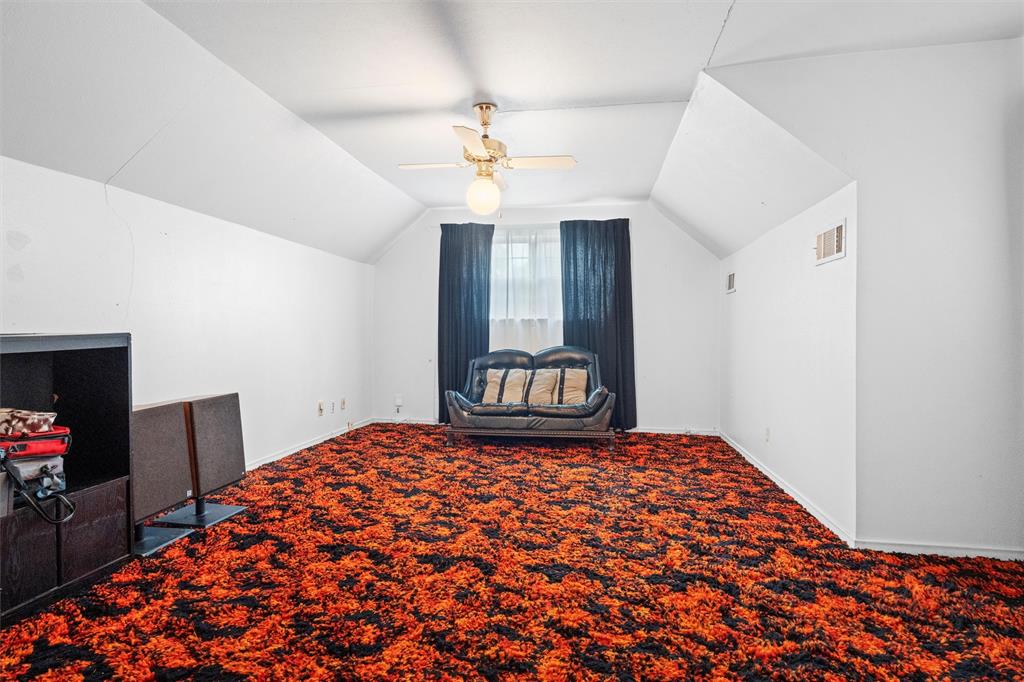 2828 Larkspur Lane Dallas, TX 75233 - Photo 27 of 31 a bedroom with a bed and a chandelier