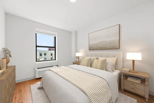 a bedroom with a bed and a lamp